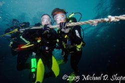 Divers Hanging at the safety stop at the end of a great d... by Michael Shope 